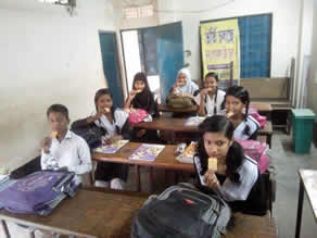 写真-7:ショマちゃん(右奥)とクッキーを食べる子どもたち